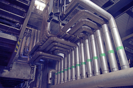 Equipment, cables and piping as found inside of a modern industrial power plant. Industrial zone,...