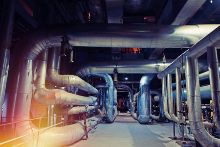 Equipment, cables and piping as found inside of a modern industrial power plant. Industrial zone, Steel pipelines, valves, cables and walkwaysの写真素材