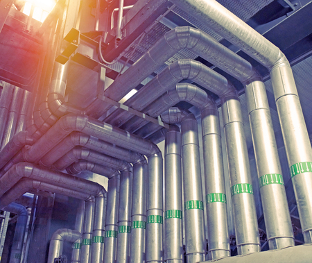 Equipment, cables and piping as found inside of a modern industrial power plant