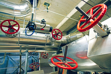 Equipment, cables and piping as found inside of a modern industrial power plant. Industrial zone,...