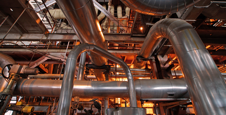 Equipment, cables and piping as found inside of a modern industrial power plant