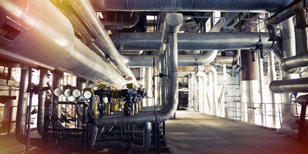 Equipment, cables and piping as found inside of a modern industrial power plant