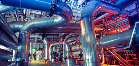 Equipment, cables and piping as found inside of a modern industrial power plant