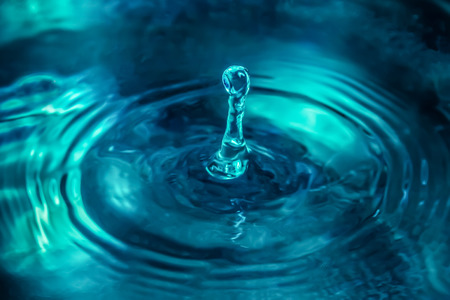 Beautiful splashing water drops in blue colorの写真素材