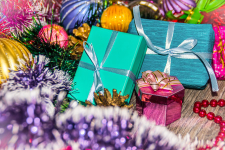 New year picture. Gifts boxes. Christmas decorations tinsel and beadsの写真素材