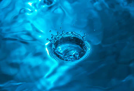 Beautiful splashing water drop (in blue color)の写真素材