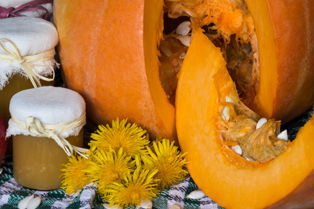 Pumpkin and pumpkin jam, puree or sauce on green with white tablecloth. Autumn still life.の写真素材
