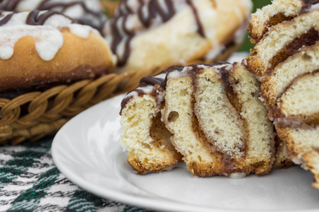 Homemade cinnabons cinnamon cut bun with cream cheese glaze and chocolate icingの写真素材