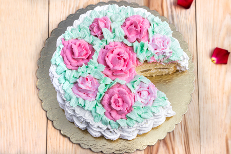 Delicious creamy cake basket of roses on wooden tableの写真素材