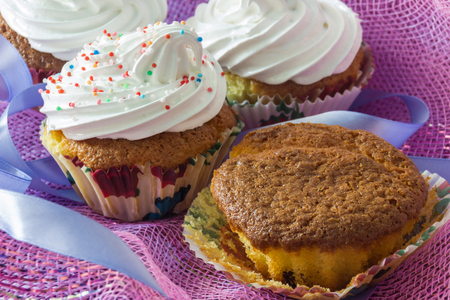 Tasty muffin cakes with and without protein creamの写真素材