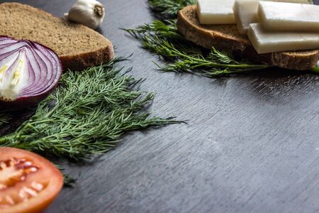 cut red onions, tomato, dill, lard (salo) and garlic on  wooden table. Small depth of focusの写真素材