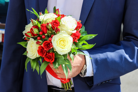 Red and white roses and hypericum, wedding bouquetの写真素材