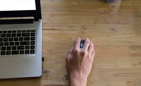 Business man using mouse and laptop, top viewの写真素材