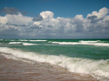 View of green tropical ocean and cloudskape