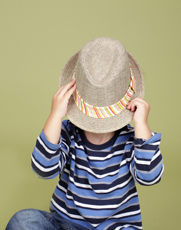 Kids, children clothing and fashion. Happy boy with a fedora hat, posing and having funの写真素材