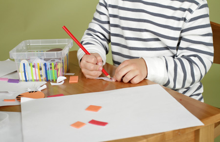 Child, kid engaged in arts and crafts activity, creative learning and education conceptの写真素材