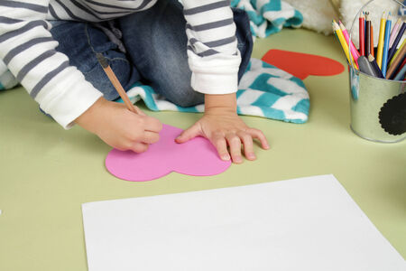 Child, kid, engaged in a Valentine's Day arts and crafts activityの写真素材