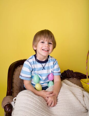 Child playing with an easter egg basket, easte egg hunt concept.
