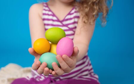 Child engaged in an Easter Activity with a Bunny and Eggs in a Basketの写真素材