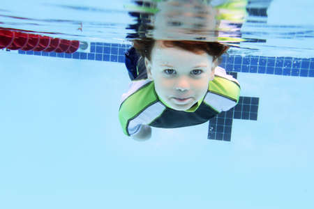 Child swimming in pool underwater, summer or sports themeの写真素材