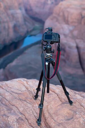 DSLR camear on a tripod overlooking the canyon and the Colorado river at Horseshoe Bend, in Page, Northern Arizonaの写真素材