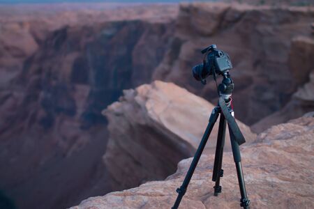 DSLR camear on a tripod overlooking the canyon and the Colorado river at Horseshoe Bend, in Page, Northern Arizonaの写真素材