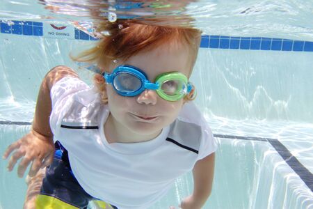 Child  swimming in pool underwater, summer or sports themeの写真素材