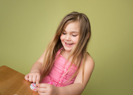 Child doing Easter activities and crafts with bunny stickers, Easter Egg shapes, pencils and markers.の写真素材