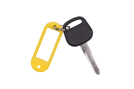 Yellow blank tag and a key isolated on white background.(With clipping path.)の写真素材