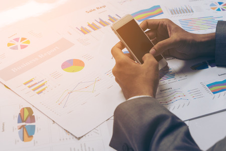 Business people hands working with a smartphone on white table background. Copy space. Vintage toneの写真素材