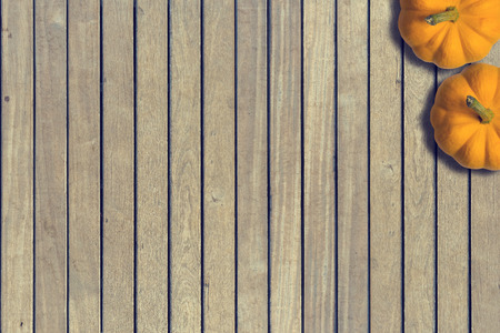 Top view of pumpkin on wooden background.Halloween concept with copy space and Vintage tone.の写真素材