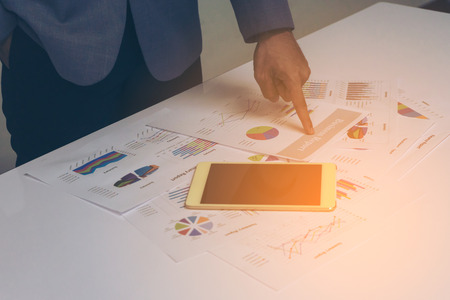 Business people hands working with a tablet on white table background. Copy space. Vintage toneの写真素材