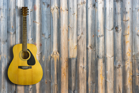 Acoustic guitar on wooden background texture.Copy spaceの写真素材