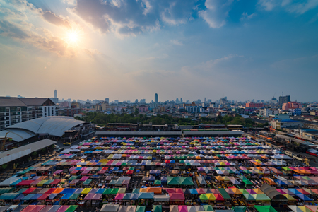 Sunset scence of Bangkok Panorama ,Aerial view of Bangkok night market in Bangkok city downtown with sunset sky and clouds at Bangkok , Thailand. And colourful tentsの写真素材