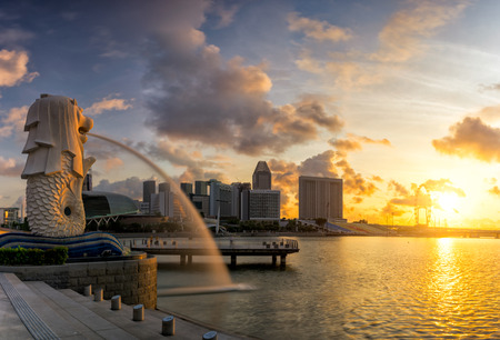 AUGUST 17, 2016 SINGAPORE : The Merlion is a traditional creature with a lion head and a body of a fish, seen as a symbol of Singapore.Landscape of the Singapore landmark financial district at sunriseのeditorial素材