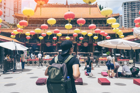 Young man traveler is visiting at Wong Tai Sin temple in Hong Kongの写真素材