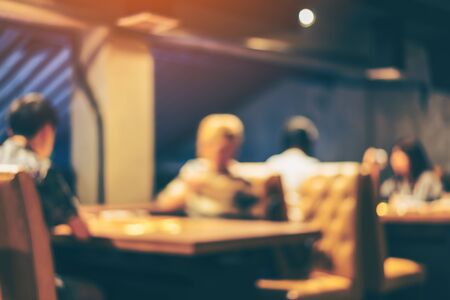 Blurred or Defocus image of restaurant or Cafeteria for use as Background with vintage tone.の写真素材