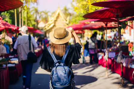 Young woman traveler traveling to Wat Phra Singh temple. This temple contains supreme examples of Lanna art in the old city center of Chiang Mai,Thailand.の写真素材