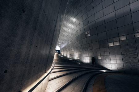 SEOUL, SOUTH KOREA - APRIL 11, 2018 : Young man traveler standing on stair of the Dongdaemun Design Plaza (DDP) at night in Seoul city,South Korea.のeditorial素材