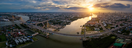 Aerial view panorama of Bhumibol suspension bridge cross over Chao Phraya River in Bangkok city with...