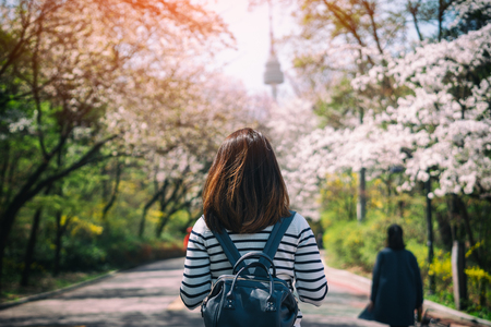 Young woman traveler backpacker traveling into N Seoul Tower at Namsan Mountain in Seoul City, South Korea.の写真素材