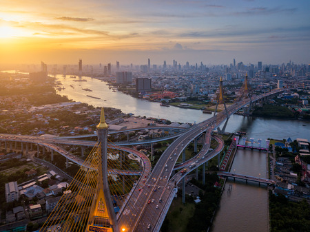 Aerial view of Bhumibol suspension bridge cross over Chao Phraya River in Bangkok city with car on...