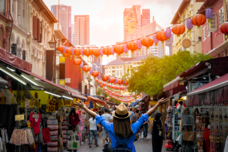 Young woman traveler with backpack and hat traveling into Chinatown at singapore city downtown. Travelling in Singapore conceptのeditorial素材