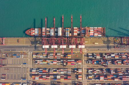 Top view of international port with Crane loading containers in import export business logistics at...