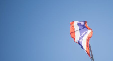 Thailand flag waving in wind on towerの写真素材