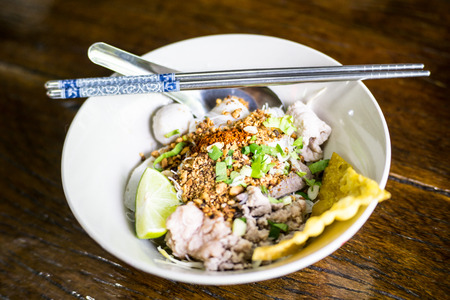 Spicy tom yum noodle with porkの写真素材