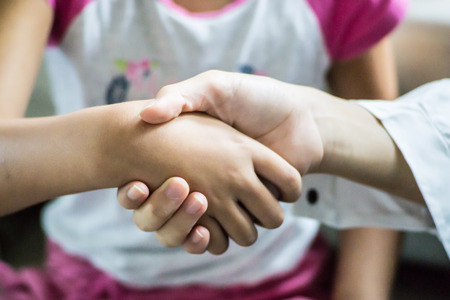 Young Asian Girls Shakehand for Stop Argue in Collaboration Conceptの写真素材