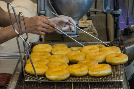 Female Chef Fried doughnut in Berkeley shop Food Dessert Conceptの写真素材