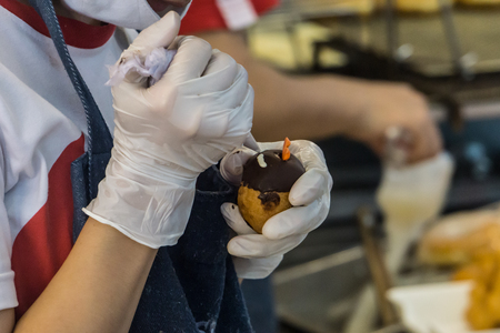 Female Chef Decorating Dessert Easter Egg in Cooking Conceptの写真素材