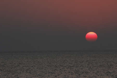 Sunset, also known as sundown, is the daily disappearance of the Sun below the horizon due to Earth's rotationの写真素材